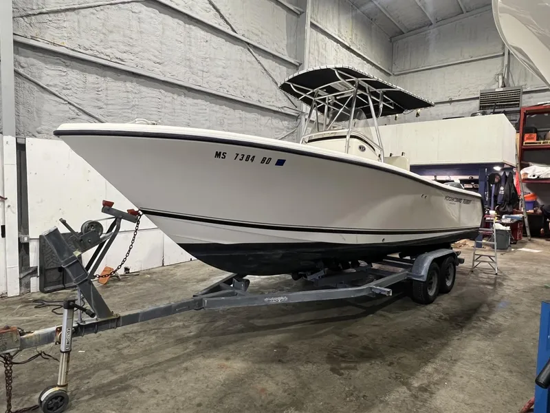 Slide: The Image of 2005 Pursuit 2570 Center Console boat on trailer in indoor storage facility. - 24
