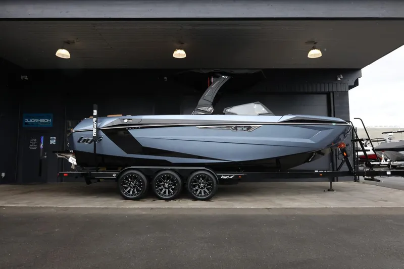 The Image of 2025 Tigé Ultré 25ZX boat on trailer in showroom, side view. - 1