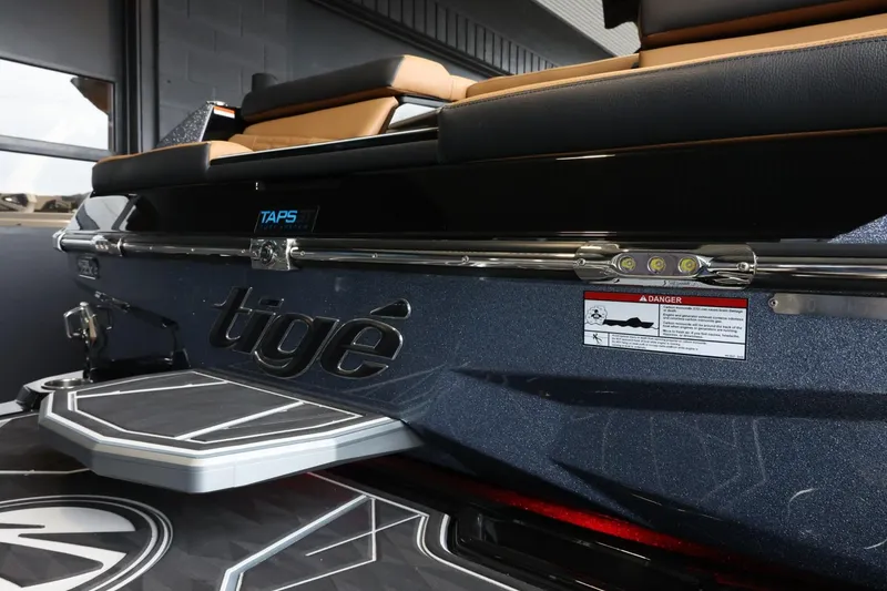 Slide: The Image of 2025 Tigé Ultré 25ZX boat rear view with TAPS system and logo. - 10
