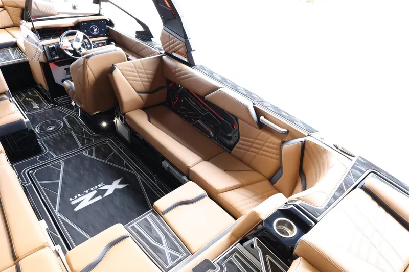 Slide: The Image of 2025 Tigé Ultré 25ZX boat interior with luxurious tan seating and modern dashboard design. - 16