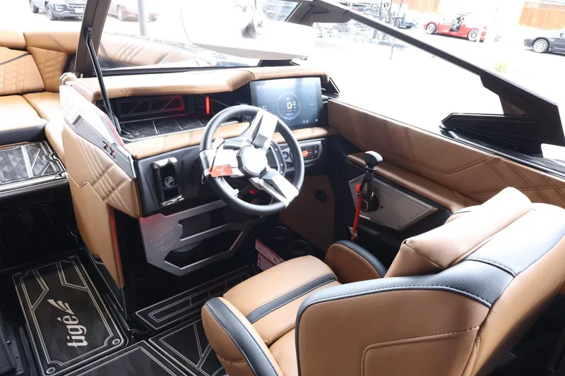 Slide: The Image of 2025 Tigé Ultré 25ZX boat interior with modern dashboard and luxurious seating. - 18