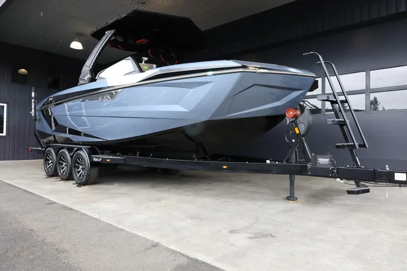 Slide: The Image of 2025 Tigé Ultré 25ZX boat on trailer, sleek design, parked in garage. - 2