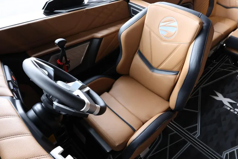 Slide: The Image of 2025 Tigé Ultré 25ZX interior with luxurious tan and black seating, modern steering wheel. - 28