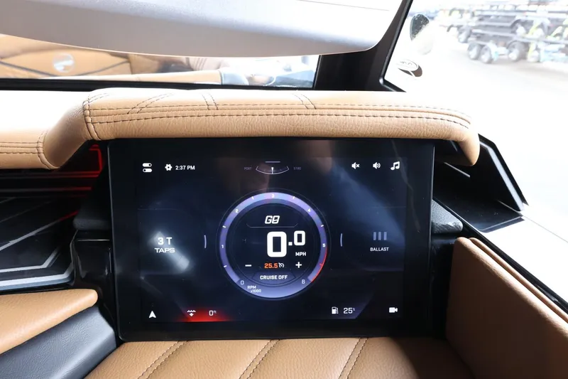 Slide: The Image of 2025 Tigé Ultré 25ZX dashboard display with digital speedometer and controls. - 32