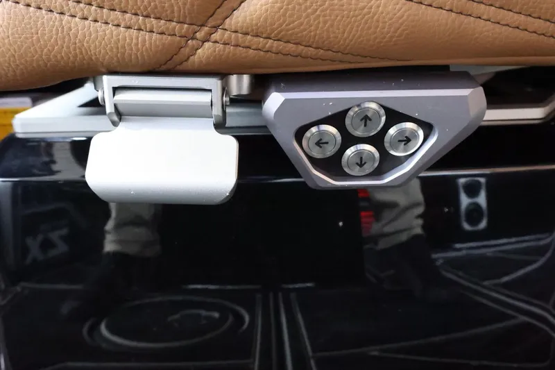 Slide: The Image of Control panel on 2025 Tigé Ultré 25ZX boat seat with brown leather upholstery. - 37