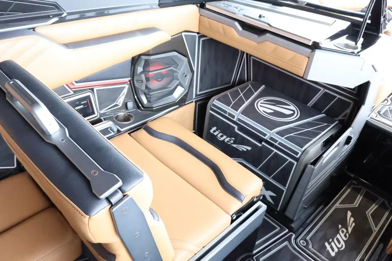Slide: The Image of Interior of 2025 Tigé Ultré 25ZX boat with tan and black seating, modern design. - 39