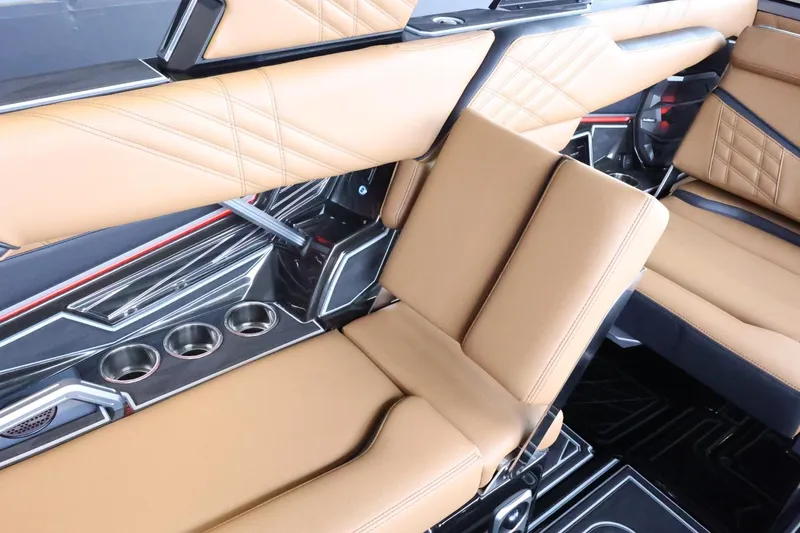 Slide: The Image of Luxurious interior of 2025 Tigé Ultré 25ZX boat with tan leather seating and cup holders. - 49