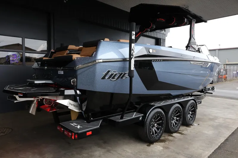Slide: The Image of 2025 Tigé Ultré 25ZX boat on a trailer, sleek design, parked indoors. - 8