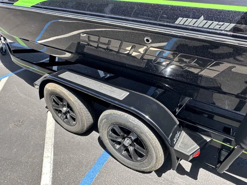 Slide: The Image of 2024 Sanger V215 S boat trailer with black wheels and green accents. - 15