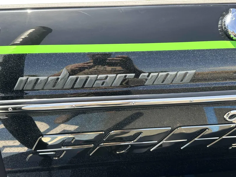 Slide: The Image of 2024 Sanger V215 S boat with Indmar 400 engine logo and green accent stripe. - 7