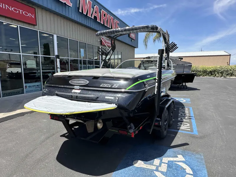 Slide: The Image of 2024 Sanger V215 S boat parked outside a marine dealership. - 9