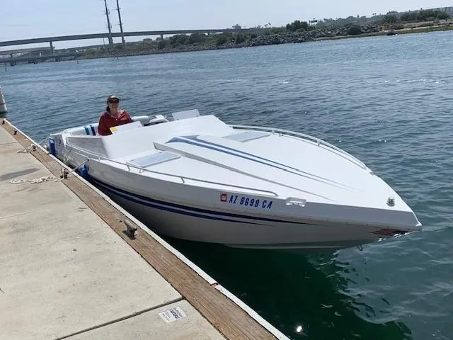 Slide: The Image of 1995 Ultimate Warlock 29 World Class boat docked on a sunny day. - 5