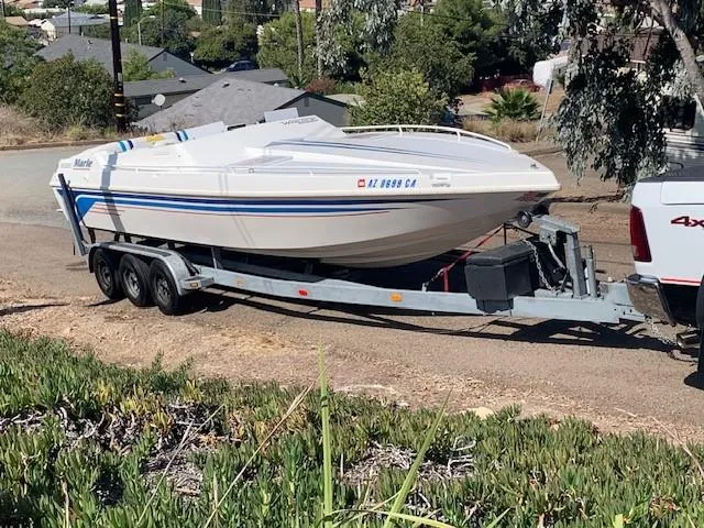 Slide: The Image of 1995 Ultimate Warlock 29 World Class boat on trailer, parked on a residential street. - 6