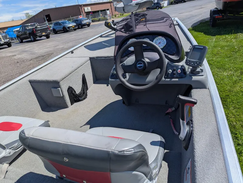 Slide: The Image of 2013 Tracker Pro 170 boat interior with steering wheel and navigation equipment. - 11