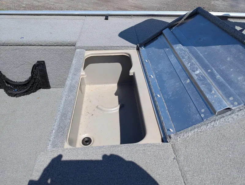 Slide: The Image of 2013 Tracker Pro 170 boat storage compartment with open lid, showing interior details. - 13