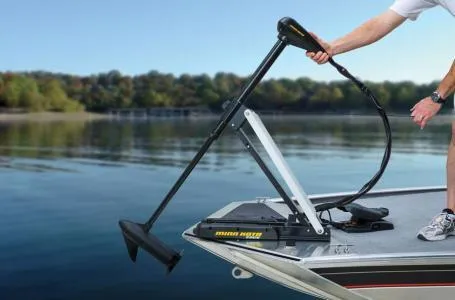 Slide: The Image of 2013 Tracker Pro 170 boat with trolling motor on a calm lake. - 6