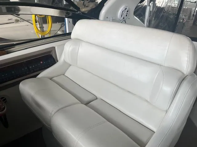 Slide: The Image of White leather seating on a 2003 Regal 3860 boat, featuring a modern dashboard. - 10