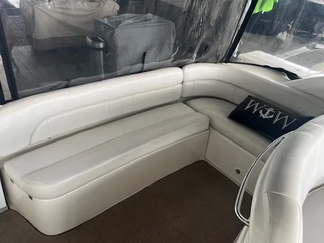 Slide: The Image of 2003 Regal 3860 yacht interior with white leather seating and decorative pillow. - 11