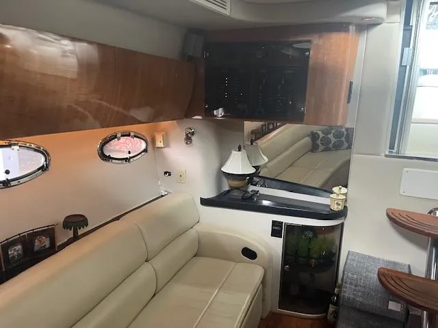 Slide: The Image of Luxurious interior of a 2003 Regal 3860 yacht with beige seating and wooden accents. - 12