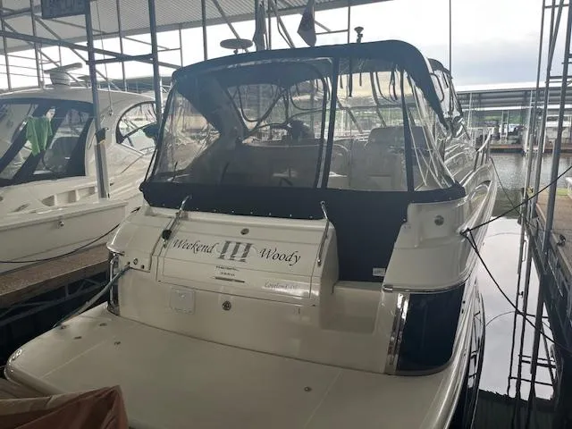 Slide: The Image of 2003 Regal 3860 yacht docked in marina, rear view with canopy. - 15