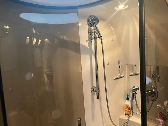 Slide: The Image of Shower area in a 2003 Regal 3860 boat, featuring modern fixtures and lighting. - 18