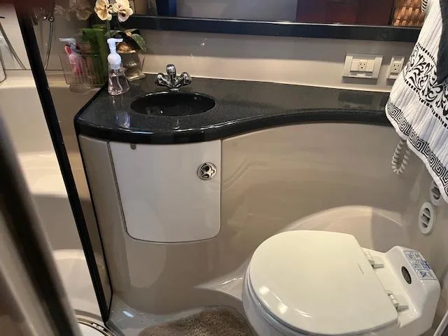 Slide: The Image of 2003 Regal 3860 yacht bathroom with modern sink, toilet, and elegant decor. - 20