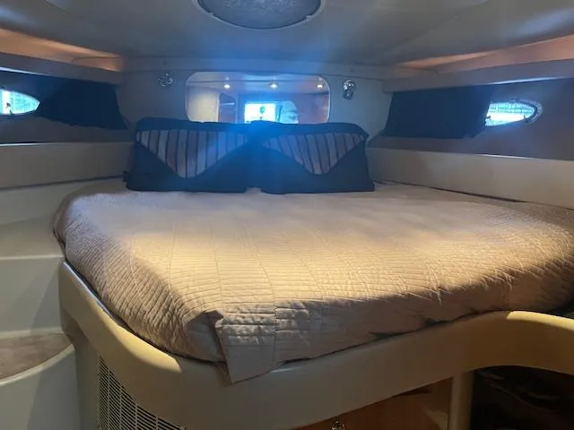 Slide: The Image of Luxurious cabin interior of 2003 Regal 3860 yacht with cozy bed and ambient lighting. - 23
