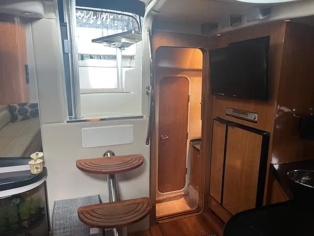 Slide: The Image of Interior of 2003 Regal 3860 yacht with wooden cabinetry and modern amenities. - 24