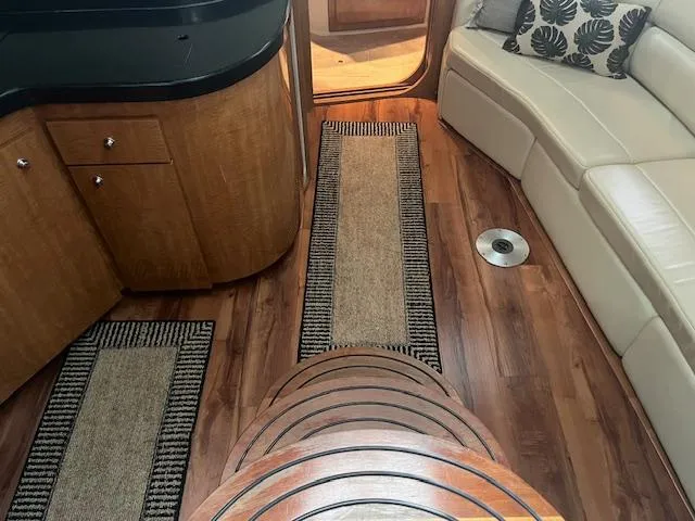 Slide: The Image of Interior of 2003 Regal 3860 yacht with wood flooring and beige seating. - 26
