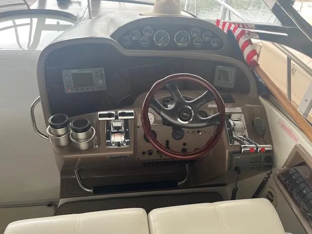 Slide: The Image of 2003 Regal 3860 boat dashboard with steering wheel and control panel. - 27