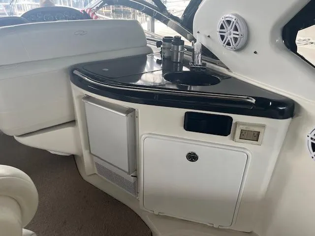 Slide: The Image of 2003 Regal 3860 yacht interior with kitchenette, sink, and storage compartments. - 28
