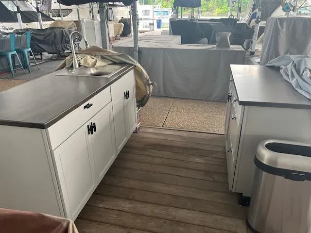 Slide: The Image of Modern outdoor kitchen on a 2003 Regal 3860 yacht with white cabinets and stainless steel sink. - 29