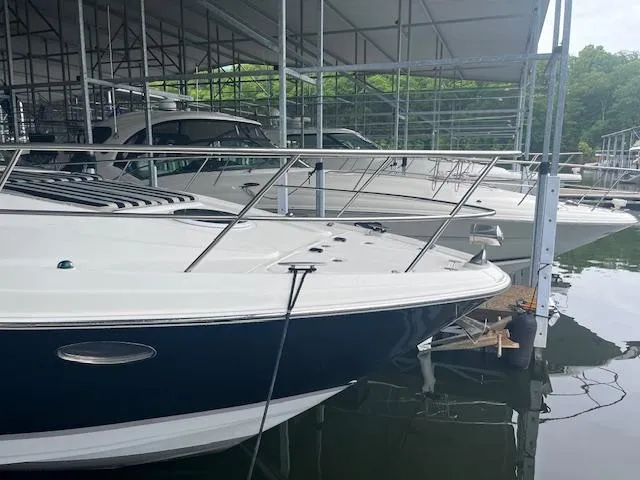 Slide: The Image of 2003 Regal 3860 boats docked in a covered marina, showcasing sleek design and luxury features. - 3