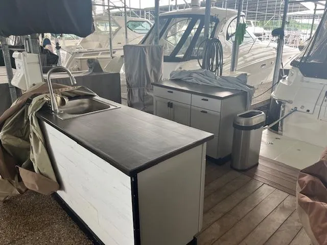 Slide: The Image of Outdoor kitchen setup on a 2003 Regal 3860 yacht with sink and cabinets. - 30