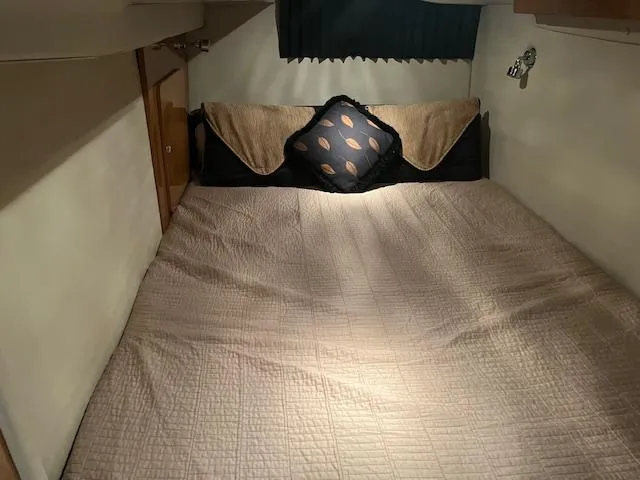 Slide: The Image of Cozy cabin bed in 2003 Regal 3860 yacht with decorative pillows and soft lighting. - 37
