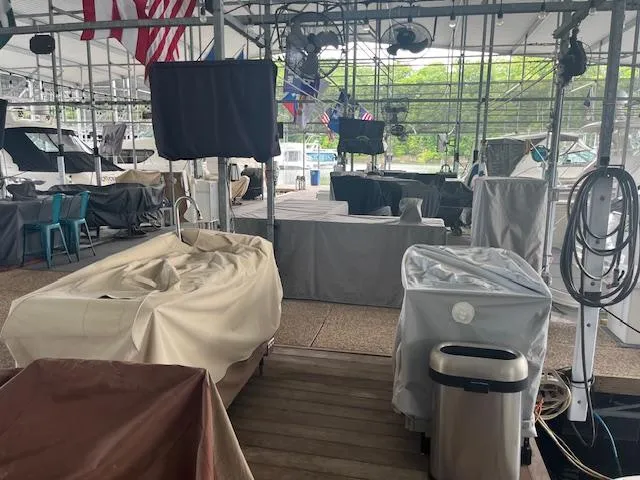 Slide: The Image of Covered boats in a marina, featuring a 2003 Regal 3860 model. - 39