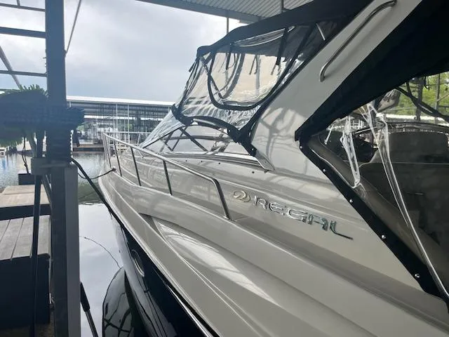 Slide: The Image of 2003 Regal 3860 yacht docked under a covered marina. - 4