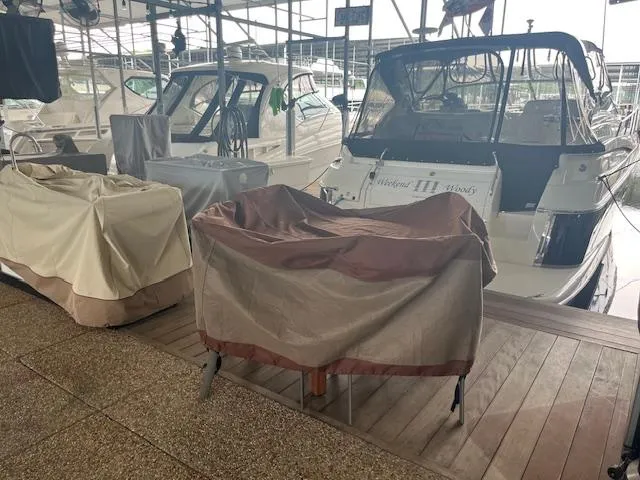 Slide: The Image of Covered boats at a marina, featuring a 2003 Regal 3860 model. - 40