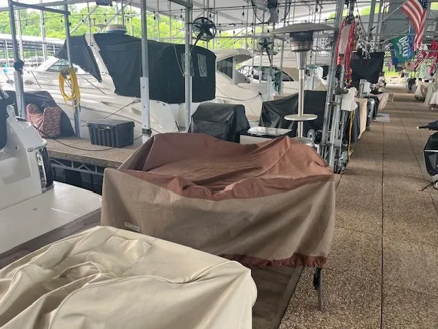 Slide: The Image of Covered boats in a marina, featuring a 2003 Regal 3860 model. - 41