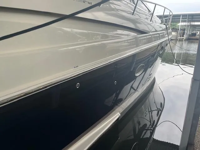 Slide: The Image of 2003 Regal 3860 yacht docked, reflecting on calm water. - 6
