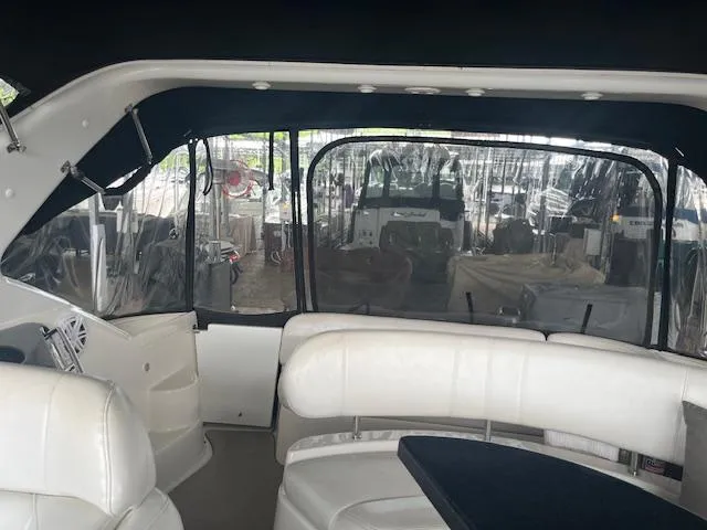 Slide: The Image of 2003 Regal 3860 yacht interior with white seating and clear windows. - 8