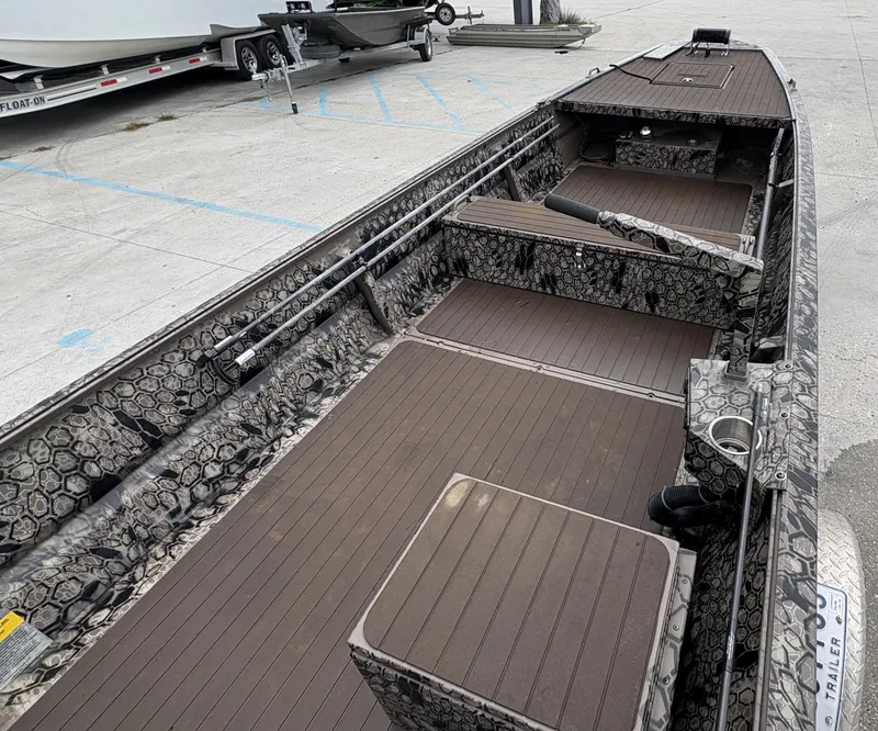 Slide: The Image of 2024 Pro-Drive X Series boat interior with camouflage design and spacious deck layout. - 11