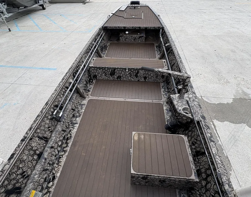 Slide: The Image of 2024 Pro-Drive X Series boat interior with camouflage design and spacious deck layout. - 12