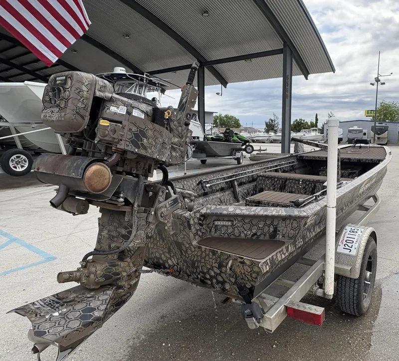 Slide: The Image of 2024 Pro-Drive X Series boat with camouflage design on a trailer, under a canopy. - 3