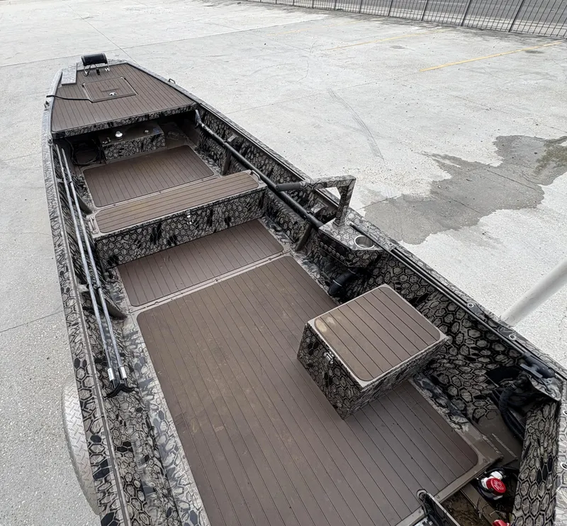 Slide: The Image of 2024 Pro-Drive X Series boat with camouflage design and spacious interior layout. - 4