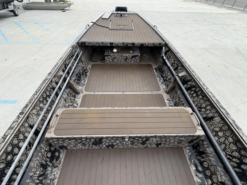 Slide: The Image of 2024 Pro-Drive X Series boat interior with camouflage design and spacious deck layout. - 6