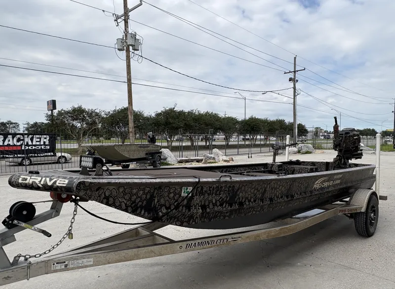Slide: The Image of 2024 Pro-Drive X Series boat on trailer, parked outdoors, showcasing sleek design and camouflage pattern. - 9