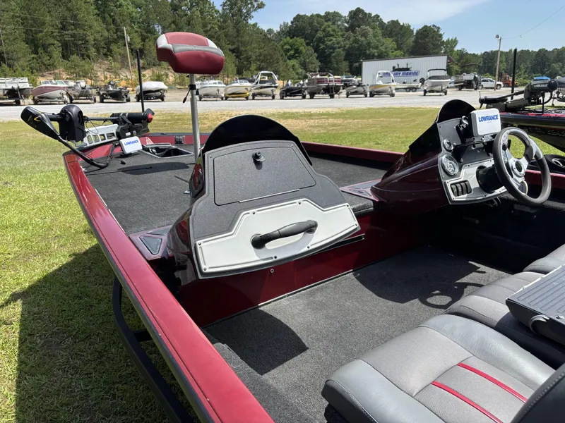 Slide: The Image of 2015 Ranger RT188 boat interior with steering wheel and Lowrance electronics, parked on grass. - 11