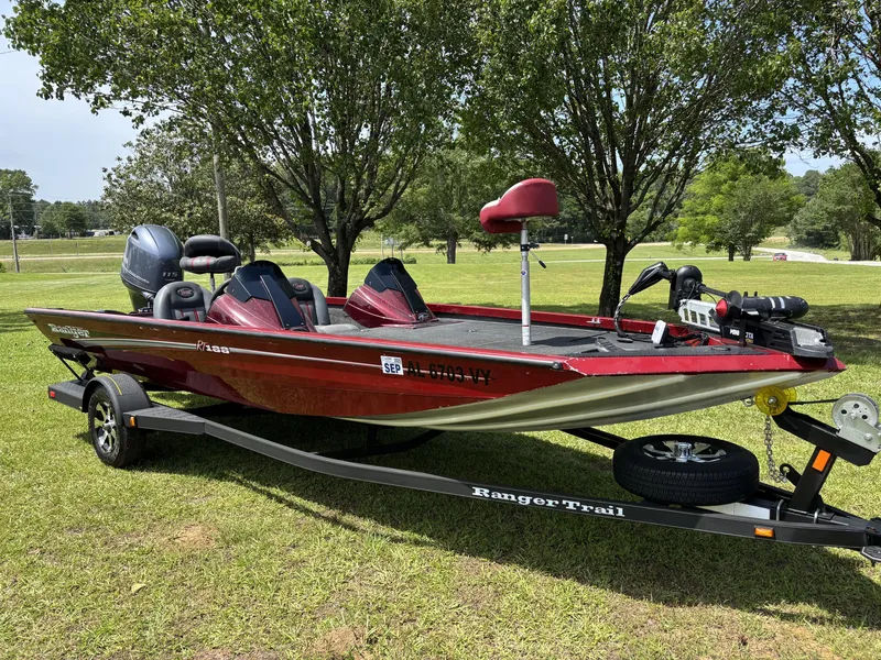 Slide: The Image of 2015 Ranger RT188 boat on trailer, parked on grass with trees in background. - 3