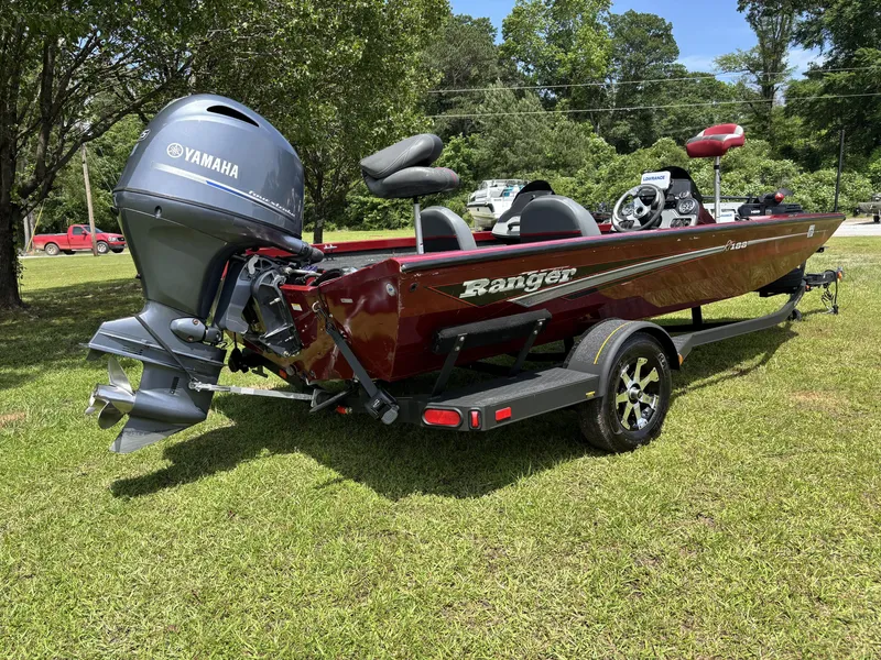 Slide: The Image of 2015 Ranger RT188 boat with Yamaha motor on grassy area, surrounded by trees. - 4